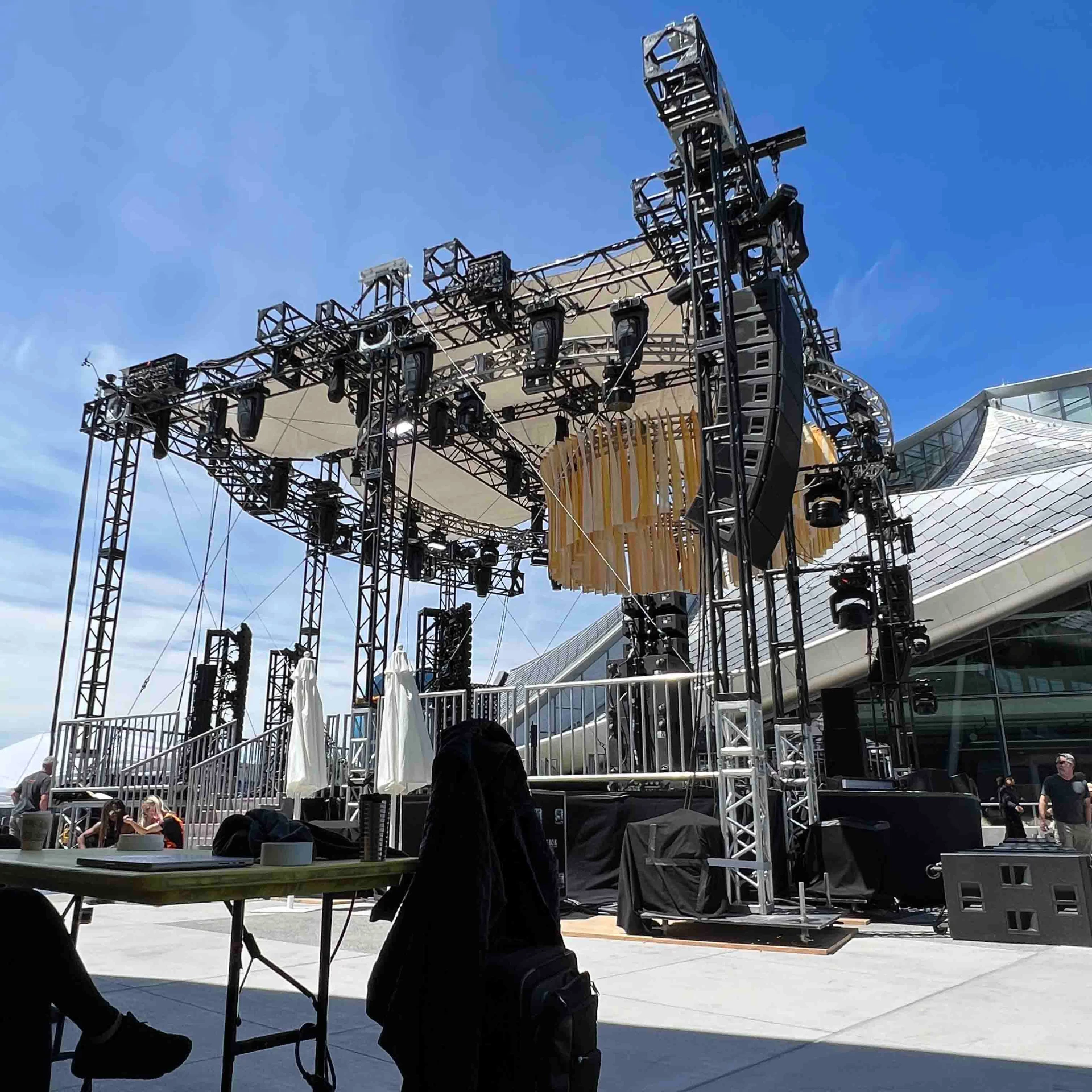 Outdoor stage truss, lighting and line array rigged for a live event